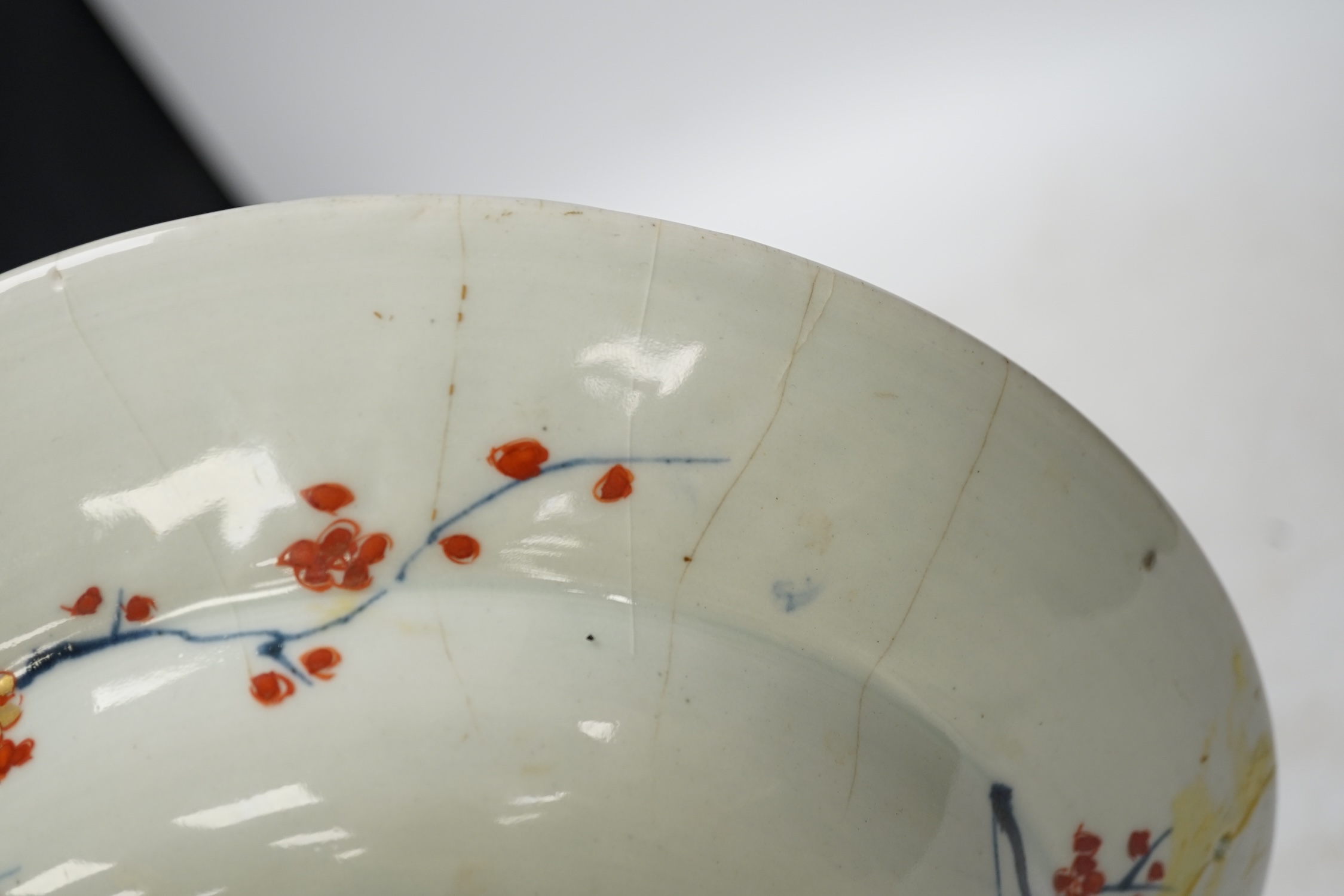 A Japanese Arita ‘cranes and chicks’ barber's bowl, early 18th century, in Imari palette, 27.5cm diameter. Condition - poor (a.f.)